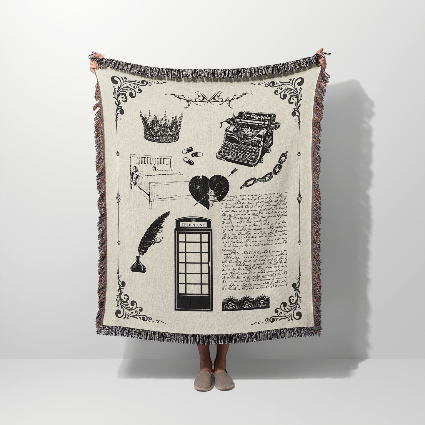 A person holding a woven blanket with design elements inspired by the Tortured Poet Music Video with blanket and white color scheme.