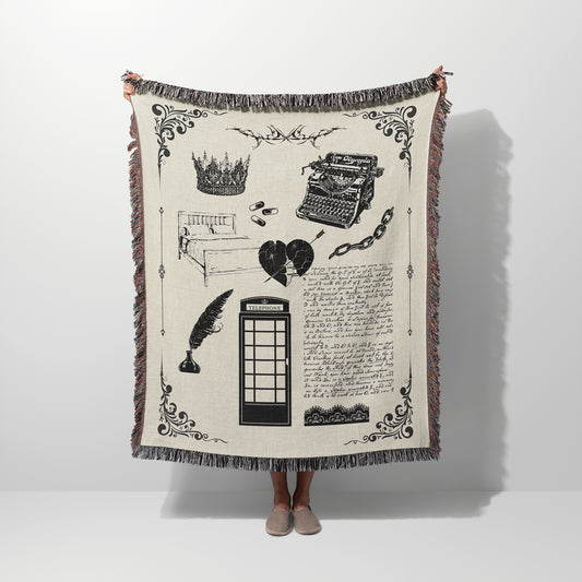 A person holding a woven blanket with design elements inspired by the Tortured Poet Music Video with blanket and white color scheme.