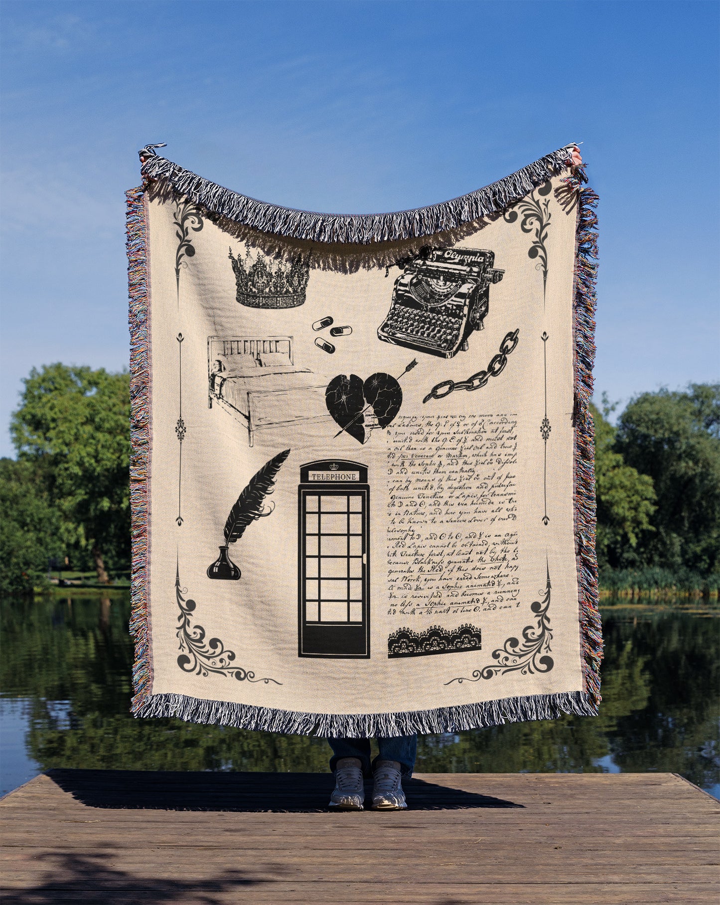 A person holding a woven blanket with design elements inspired by the Tortured Poet Music Video with blanket and white color scheme.