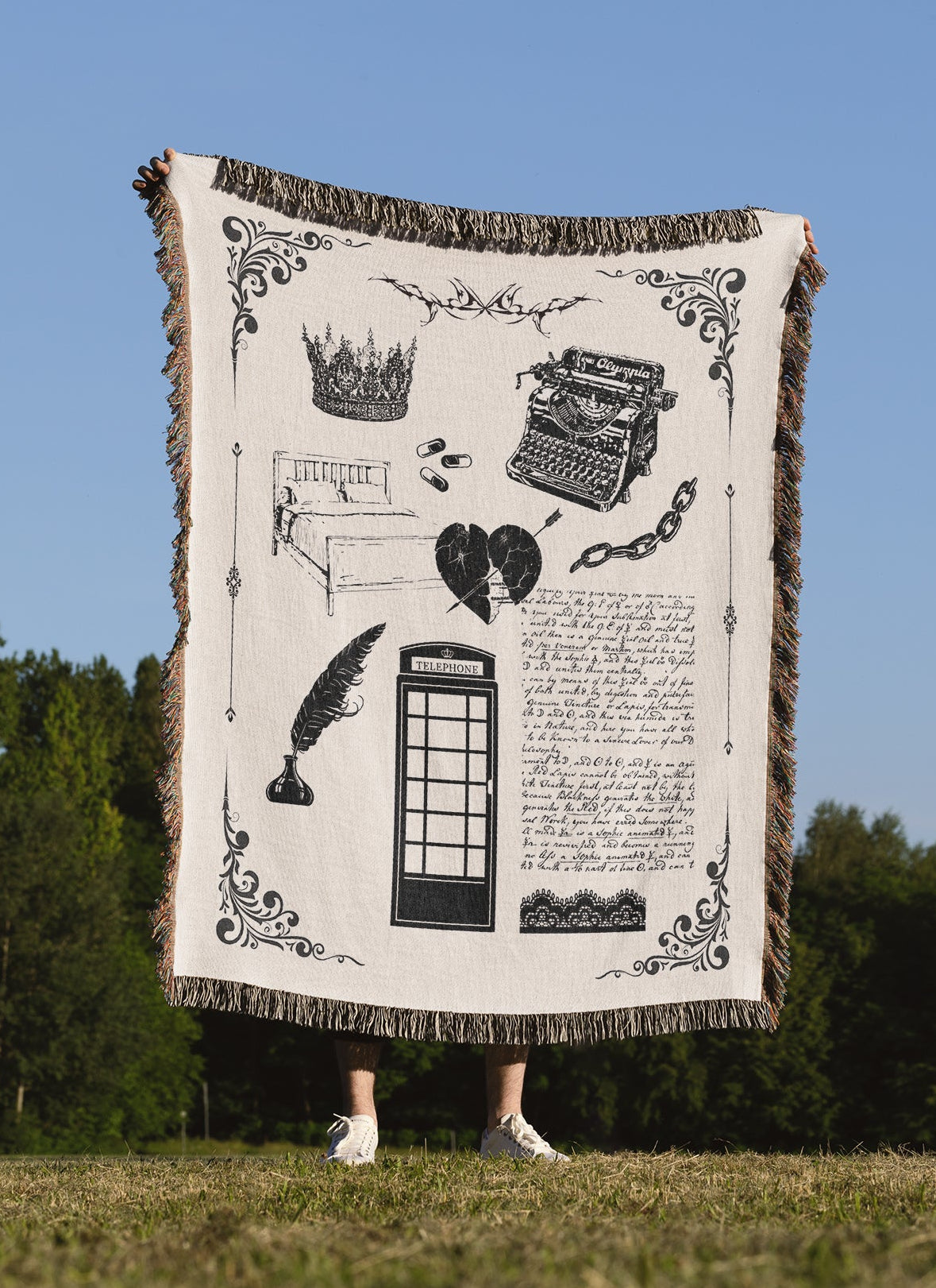 A person holding a woven blanket with design elements inspired by the Tortured Poet Music Video with blanket and white color scheme.