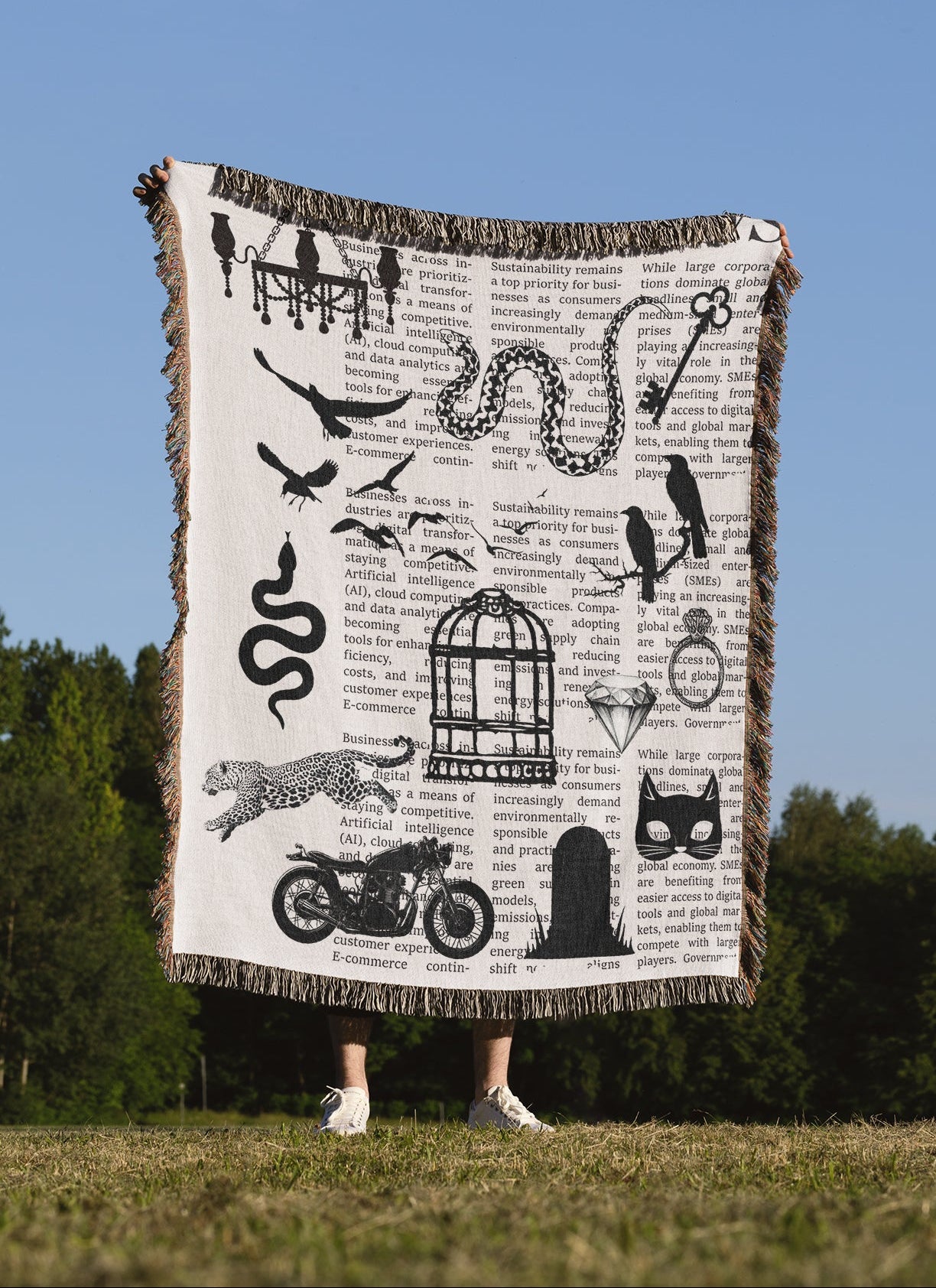 Person holding a woven blanket with designs inspired by the Rep Era in black and white color scheme