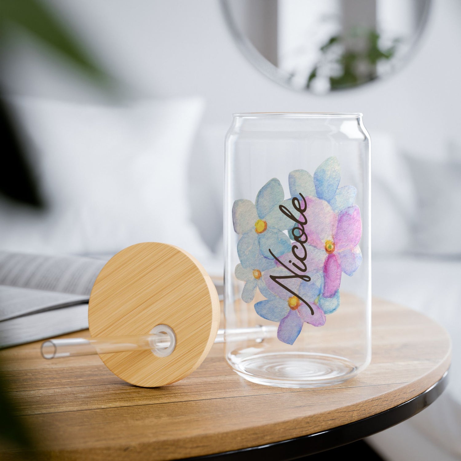 A picture of our 16 Oz Sipper Glass with Straw and Bamboo Lid with the name Nicole and a pretty blue hydrangea Flower background. Name is customizable and there are 4 Flower background options to choose from.