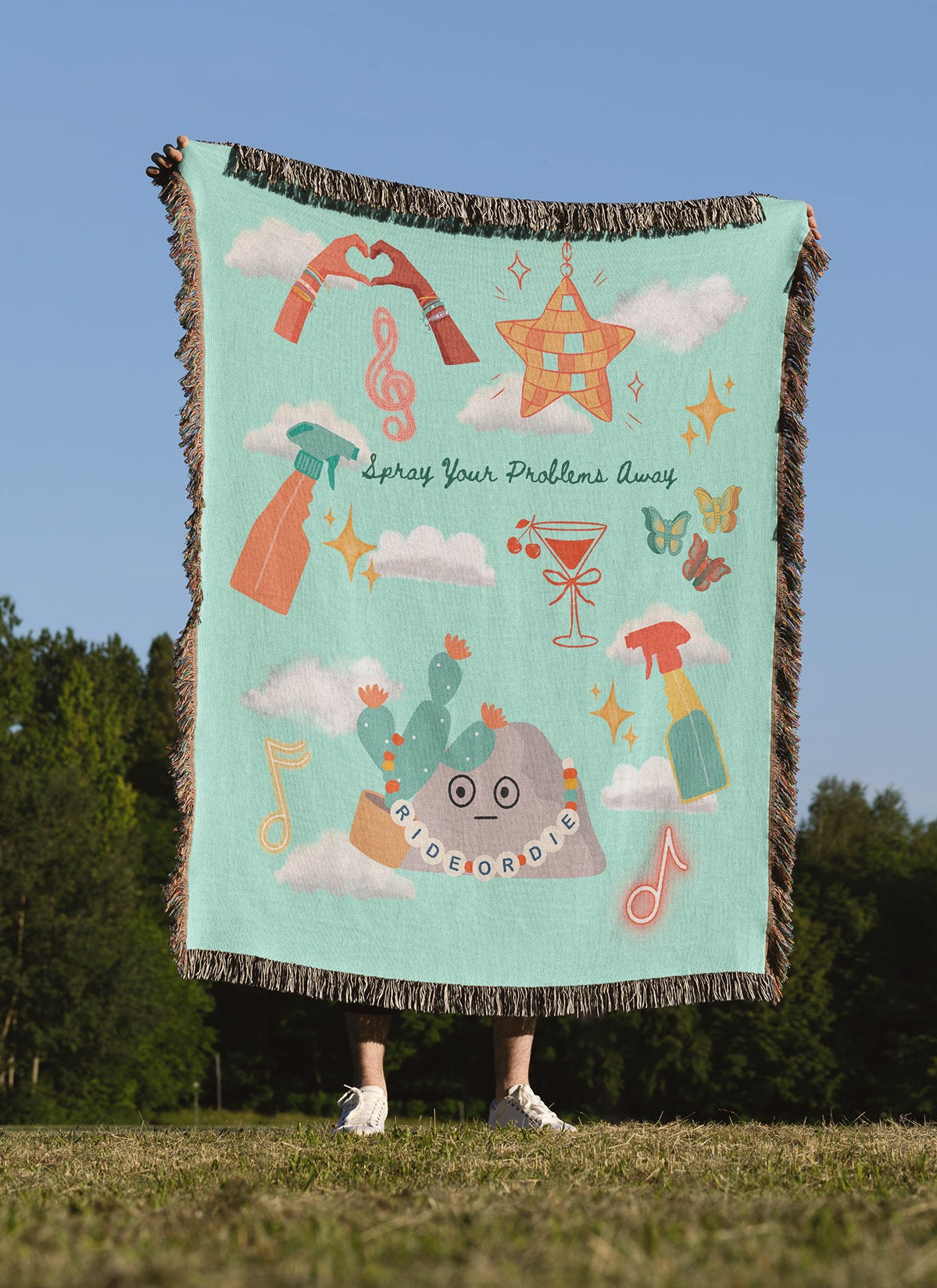 Person holding a colorful blanket with design elements inspired by Taylor's latest Music Video 