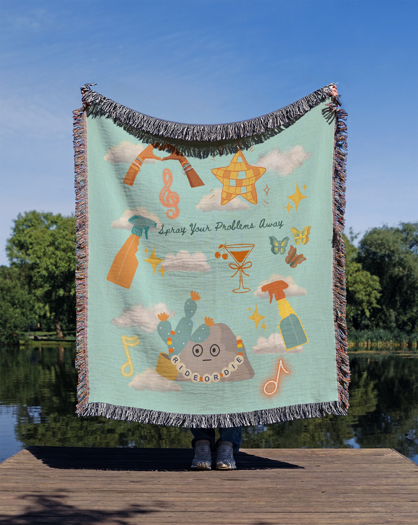 Person holding a colorful blanket with design elements inspired by Taylor's latest Music Video 