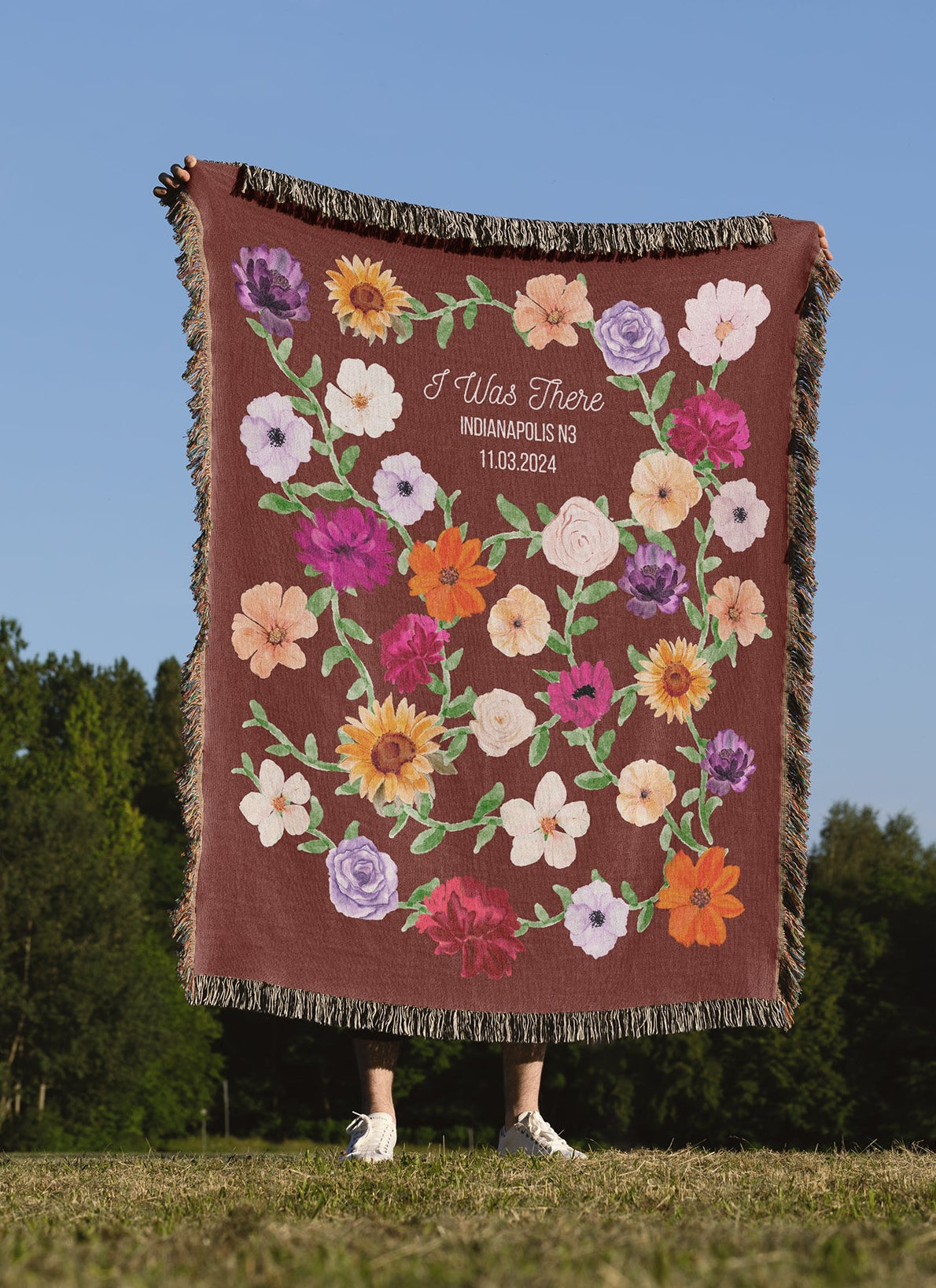 Person holding a woven blanket with floral pattern inspired by the famous Surprise Song Piano