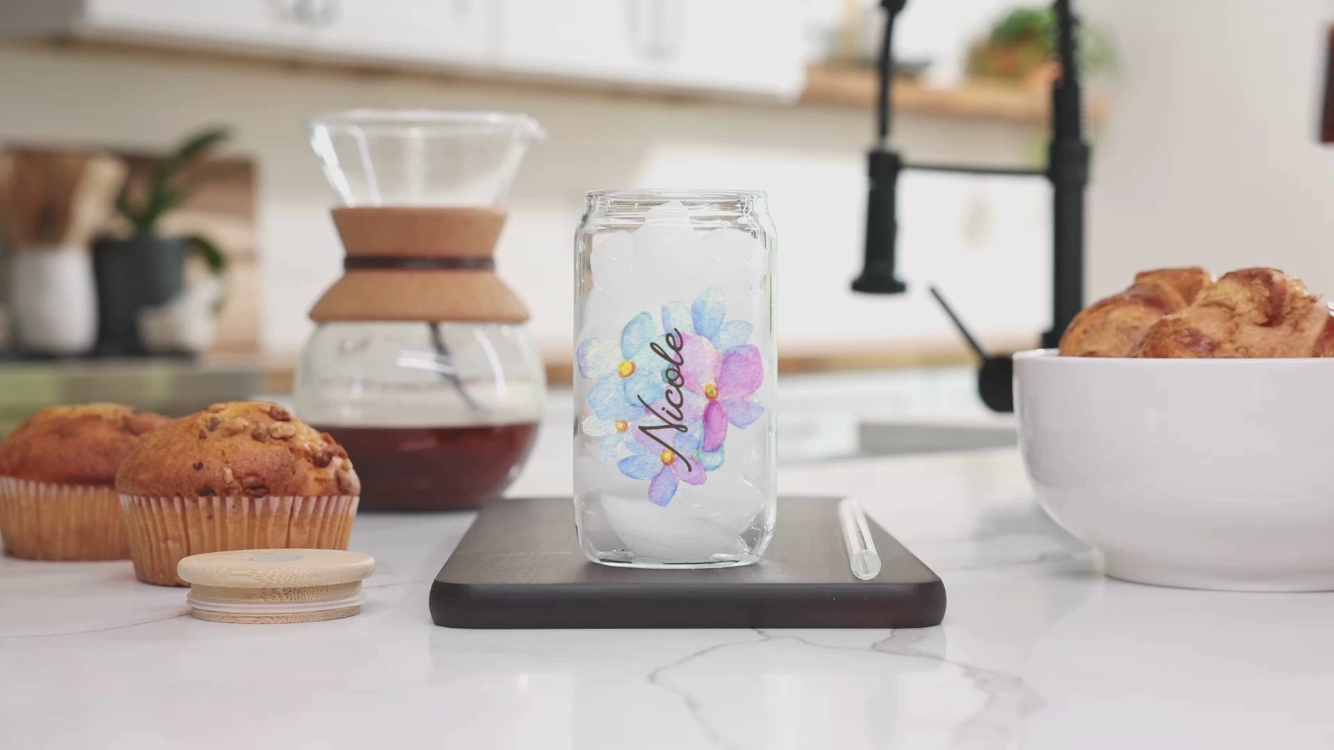 A video of milk being poured into the coffee mix inside our 16 Oz Sipper Glass with the name Nicole and pretty Blue Hydrangea Flower background. Name is customizable and there are 4 Flower background options to choose from.