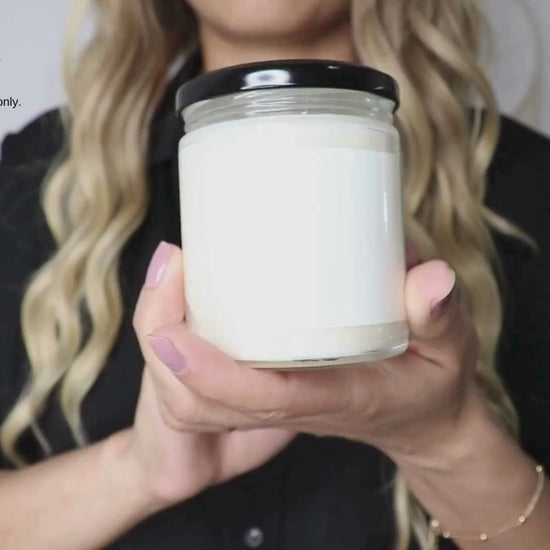 A video of a woman showing our 9 Oz soy wax candle for size reference only. There is design on this label. This video is to give customers an idea of the real life size of the candle jars. 